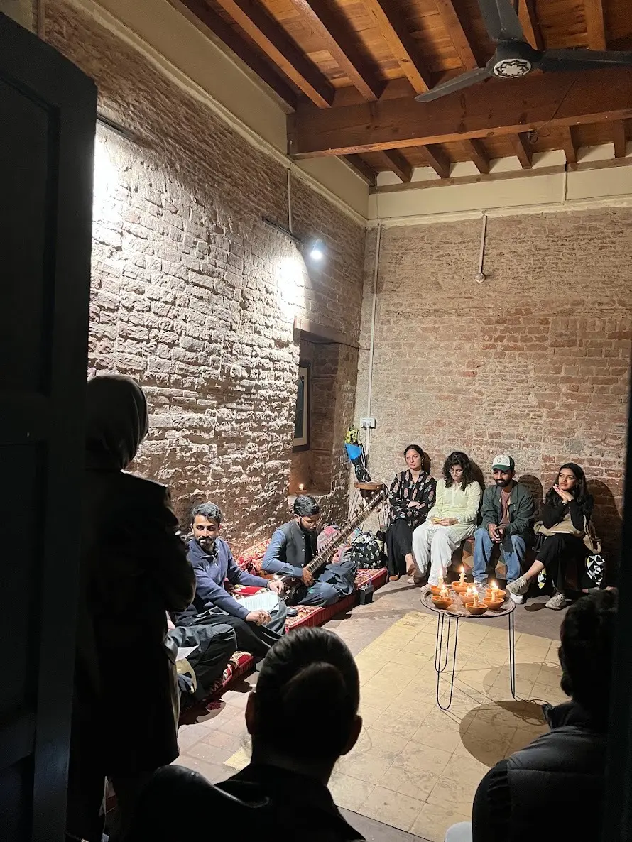 A Sangat gathering in a brick-walled room